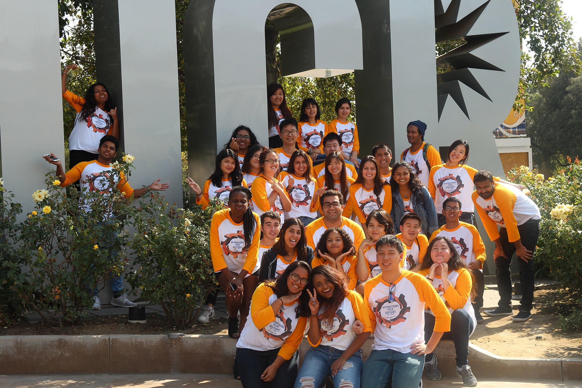Group of UCR students posing in front of UCR letters
